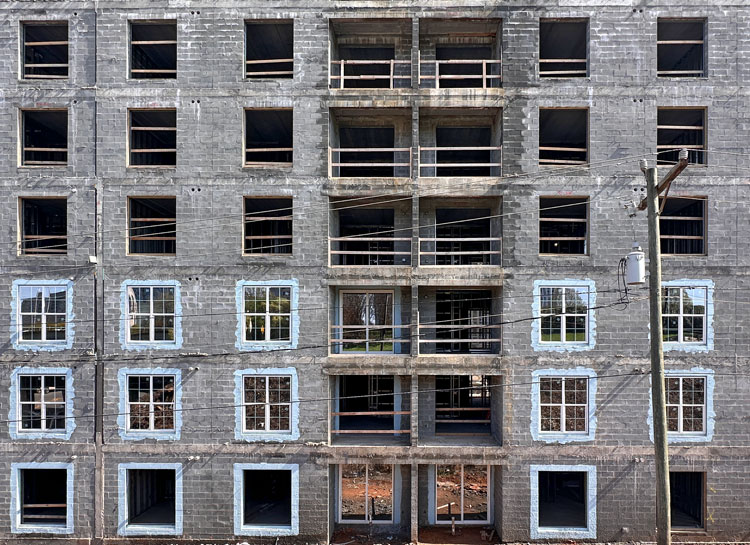 Multi-story commercial building under construction with concrete masonry unit walls